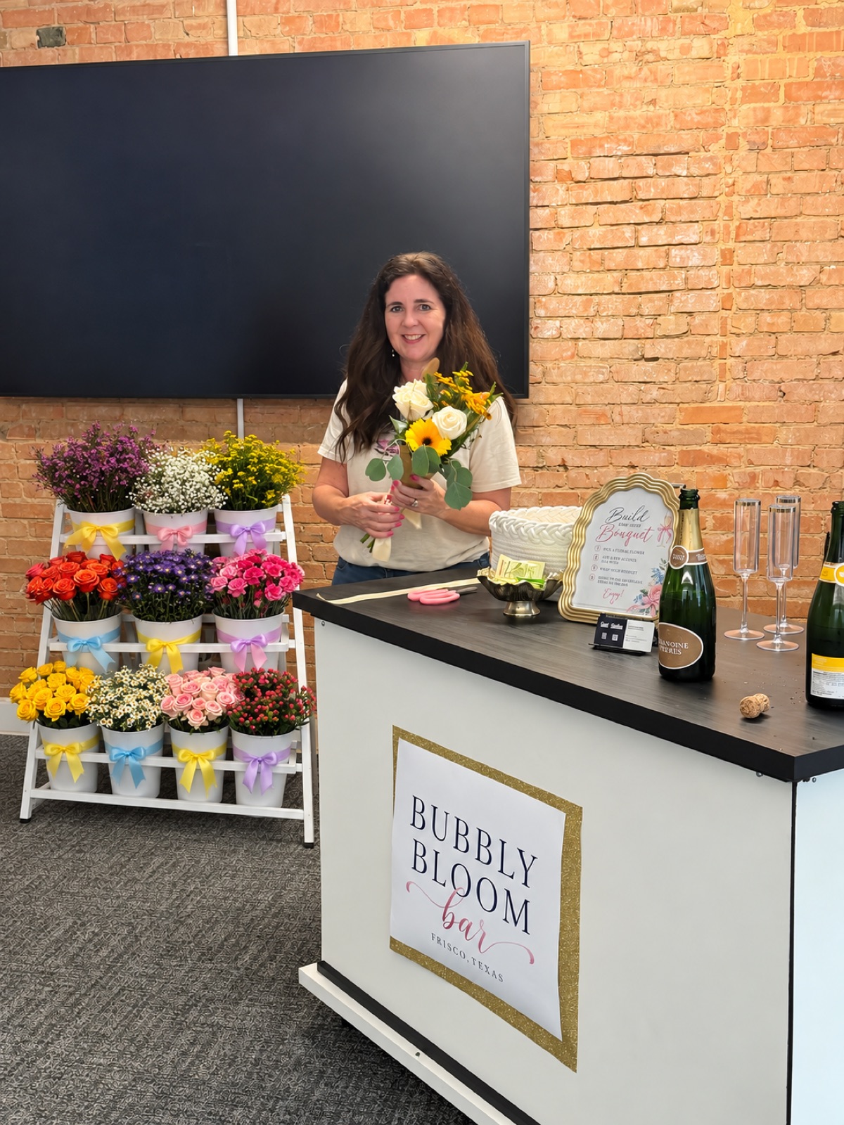 Your host · Deborah holding a bouquet at the Bubbly Bloom Bar