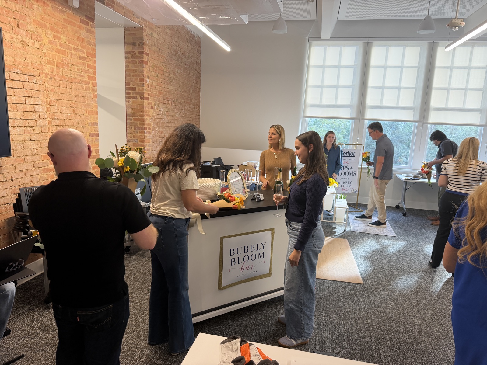 At a BBB gathering · Deborah and guests gathering around the Bubbly Bloom Bar indoors