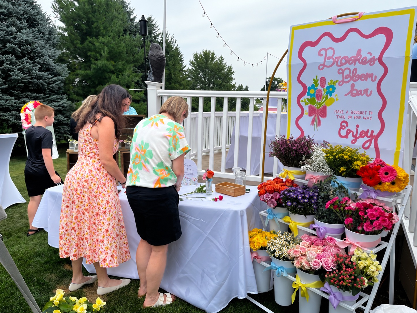 At a BBB gathering · Guests choosing flowers outdoors