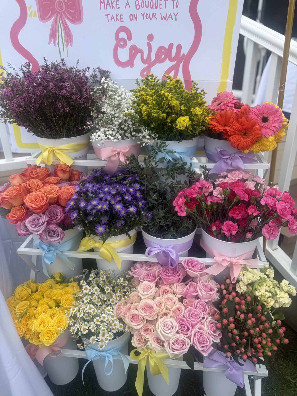 At a BBB gathering · Colorful fresh stems in ribboned buckets