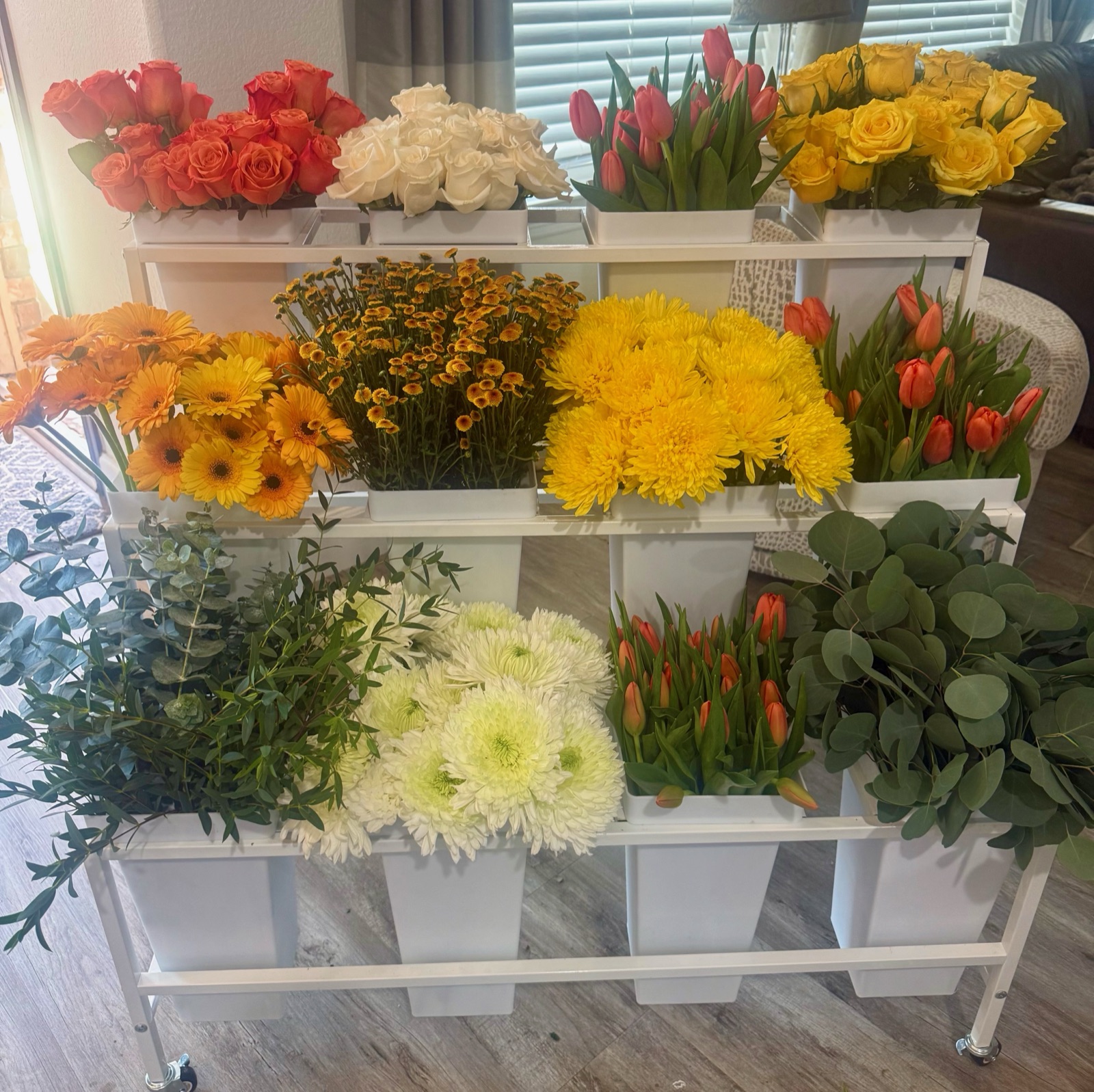 At a BBB gathering · Coral, ivory and yellow roses, tulips and greenery ready for guests